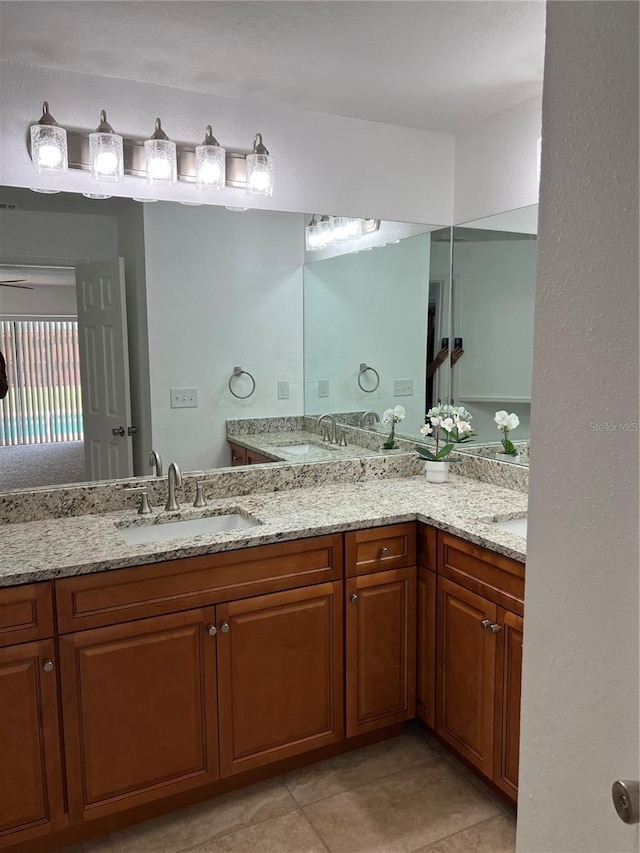 bathroom with tile patterned floors and vanity