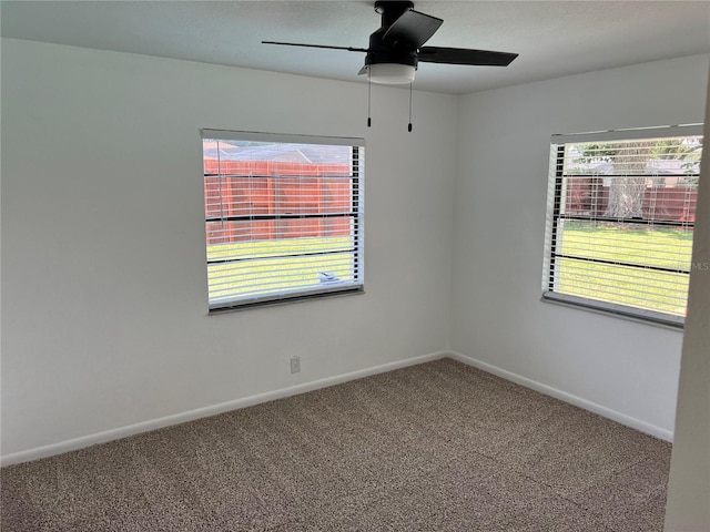 spare room featuring ceiling fan and carpet