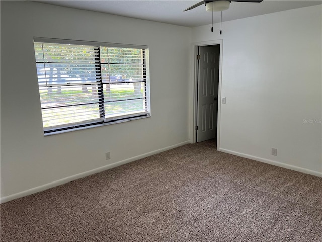 empty room with ceiling fan and carpet