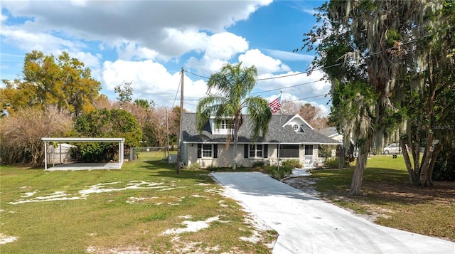 new england style home with concrete driveway and a front yard