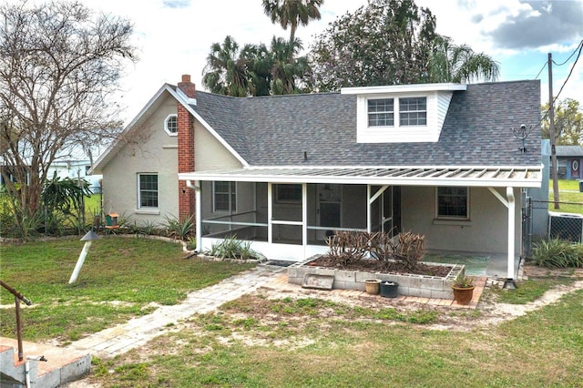 back of house with central AC unit, a sunroom, a yard, roof with shingles, and a chimney