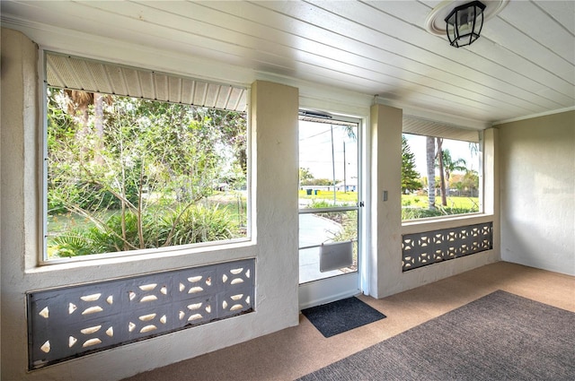 unfurnished sunroom with wood ceiling