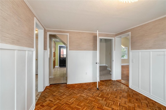 interior space with stairs, wainscoting, and crown molding