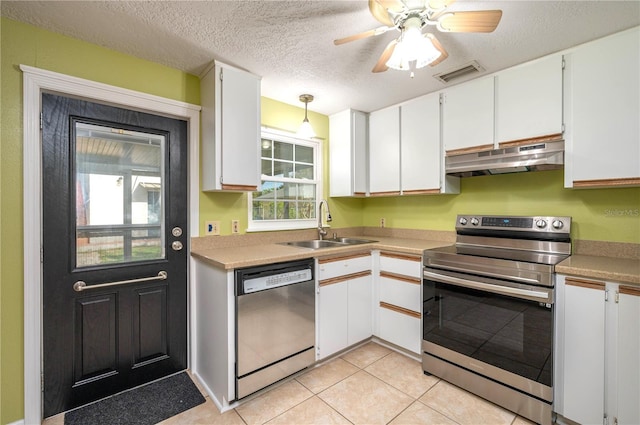 kitchen with under cabinet range hood, a sink, white cabinetry, visible vents, and appliances with stainless steel finishes