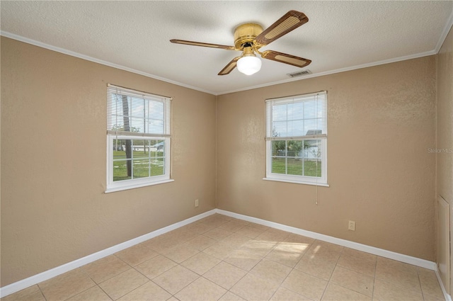 empty room with visible vents, crown molding, a textured ceiling, and baseboards