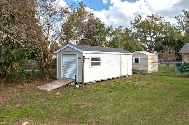 view of shed featuring fence