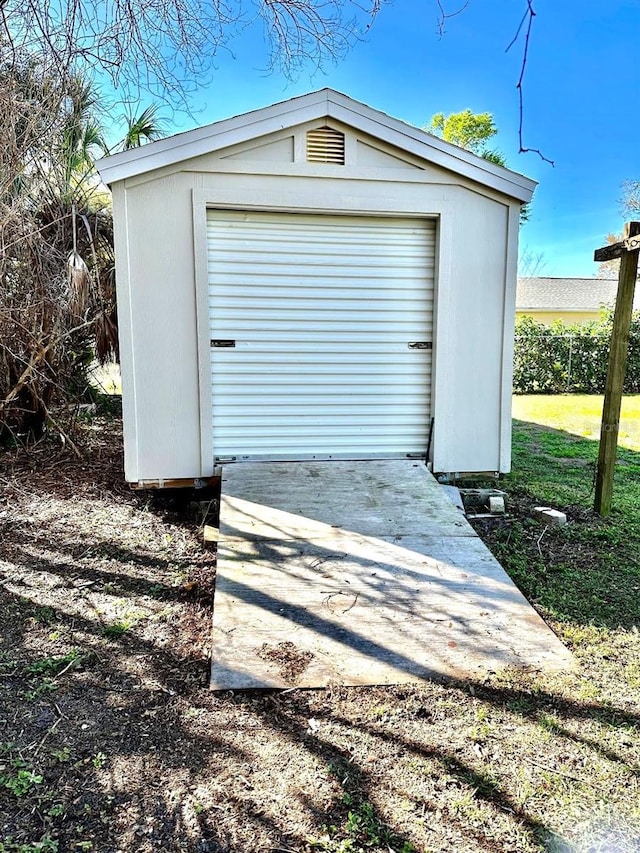 garage with a shed and concrete driveway