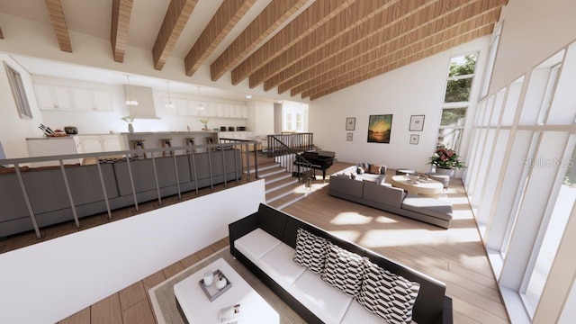 living room with a towering ceiling, wood-type flooring, and beamed ceiling