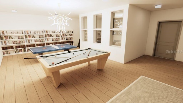 playroom featuring wood-type flooring and a chandelier