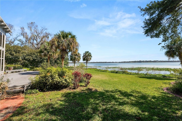 view of yard featuring a deck with water view