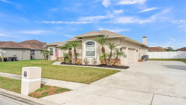 view of front of house with a garage, central AC unit, and a front lawn