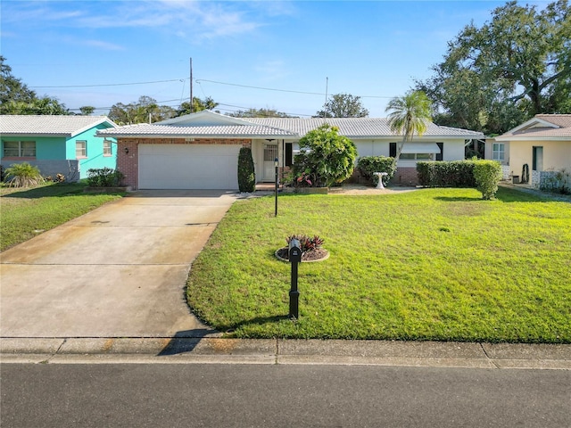 single story home featuring a garage and a front lawn