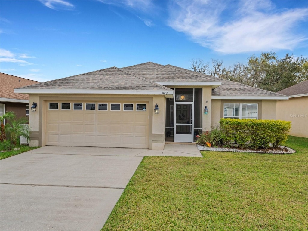 view of front of house featuring a garage and a front lawn