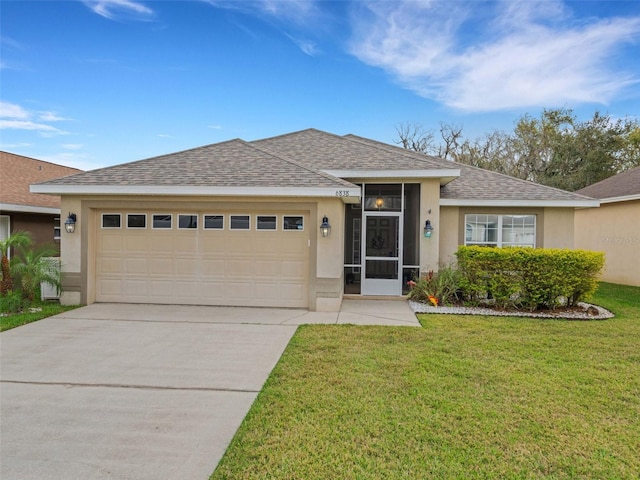 view of front of house featuring a garage and a front lawn