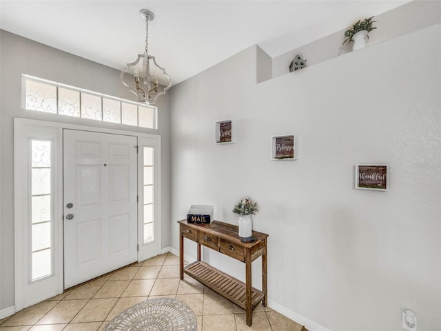 tiled entryway featuring an inviting chandelier