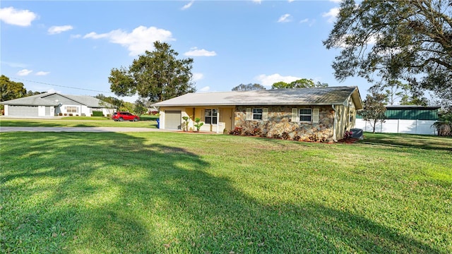 ranch-style home with a garage and a front lawn