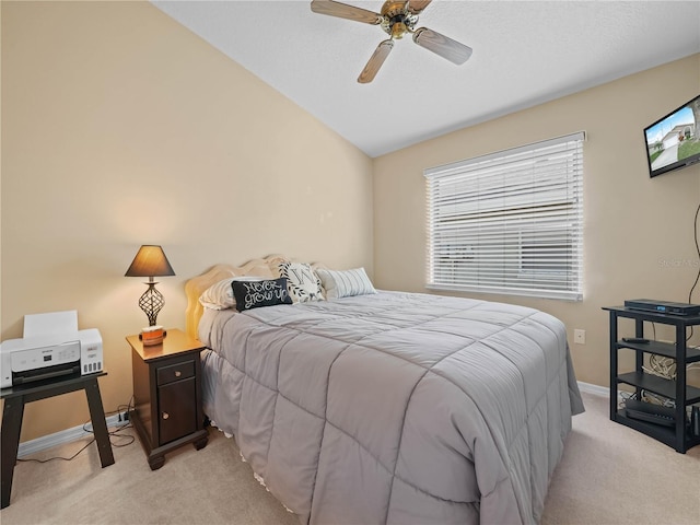 bedroom with light carpet, vaulted ceiling, and ceiling fan