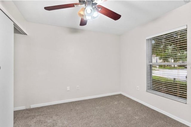 unfurnished room featuring light colored carpet and ceiling fan