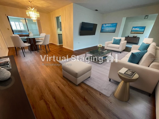 living room with hardwood / wood-style flooring and a chandelier