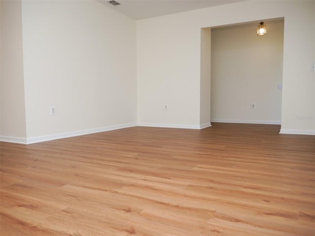 unfurnished room with hardwood / wood-style flooring