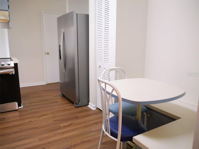 kitchen featuring dark wood-type flooring and stainless steel appliances