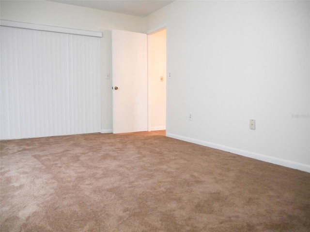 unfurnished bedroom featuring a closet and carpet