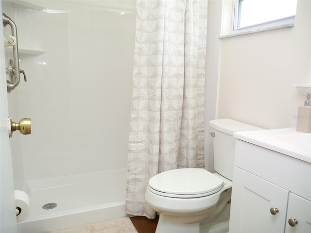 bathroom featuring vanity, toilet, and curtained shower