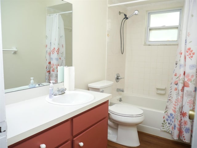 full bathroom with vanity, wood-type flooring, shower / tub combo, and toilet