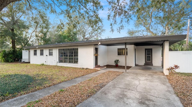 single story home featuring a carport and a front yard