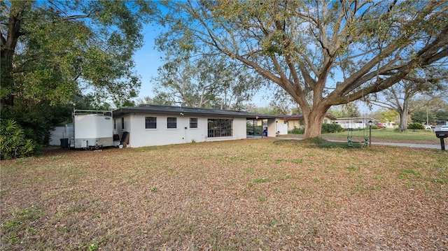 rear view of property with a lawn