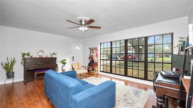 living room featuring crown molding, ceiling fan, and dark hardwood / wood-style flooring