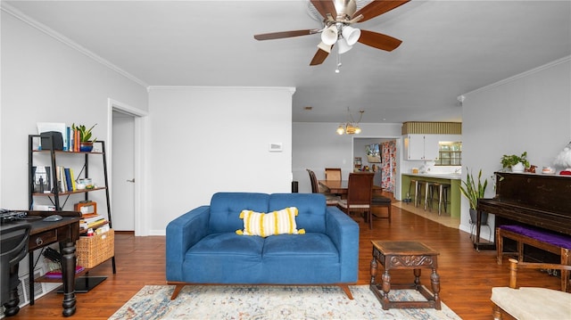 living room featuring crown molding, ceiling fan, and wood-type flooring