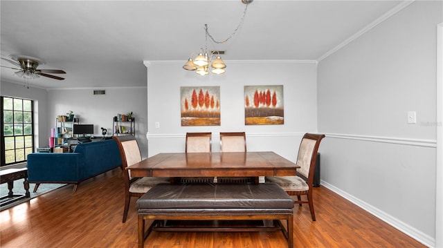 dining room with hardwood / wood-style flooring, ornamental molding, and ceiling fan with notable chandelier