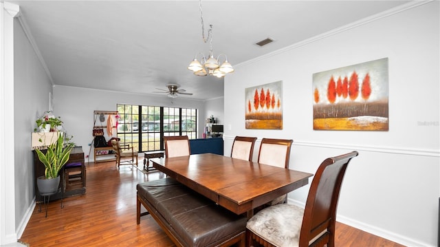 dining area featuring crown molding, wood-type flooring, and ceiling fan with notable chandelier