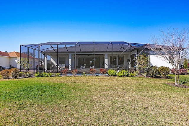 rear view of property with a yard and glass enclosure