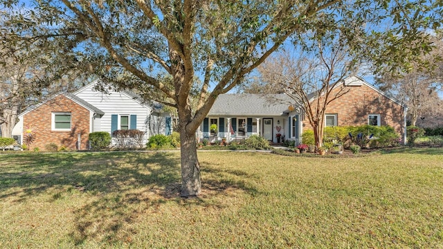 ranch-style home with a front lawn and covered porch