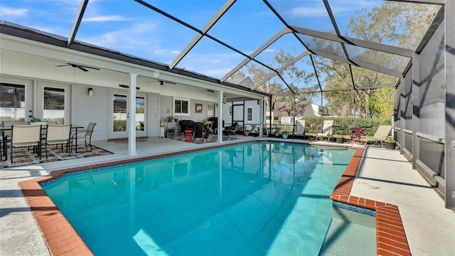 view of swimming pool featuring a lanai, ceiling fan, and a patio area