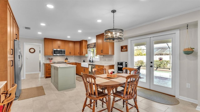 dining area with crown molding, plenty of natural light, and french doors