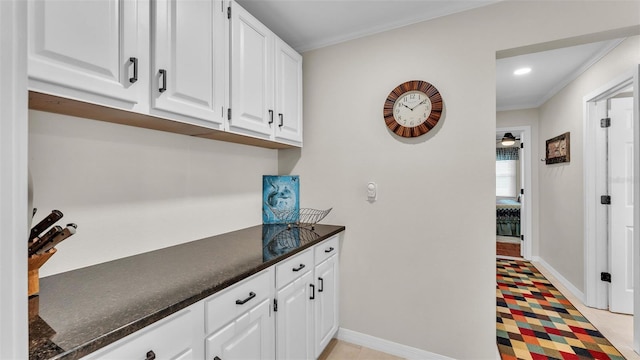 interior space with white cabinetry and ornamental molding