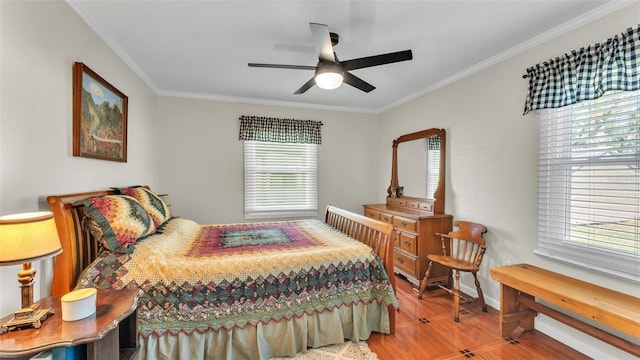 bedroom with crown molding, ceiling fan, and hardwood / wood-style flooring