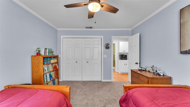 carpeted bedroom with crown molding, a closet, and ceiling fan