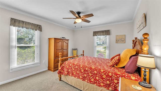 carpeted bedroom featuring crown molding and ceiling fan