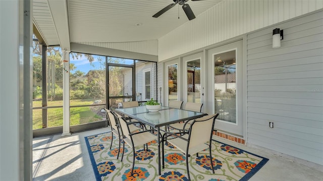 sunroom / solarium featuring ceiling fan, plenty of natural light, and vaulted ceiling