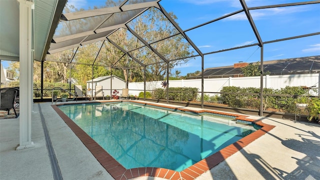 view of pool featuring a patio and glass enclosure