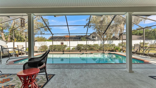 view of swimming pool featuring a lanai and a patio