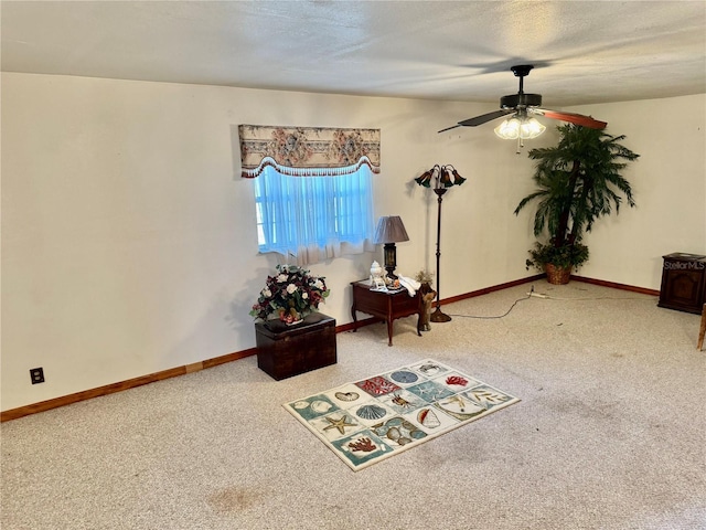 interior space with ceiling fan, a textured ceiling, and carpet flooring