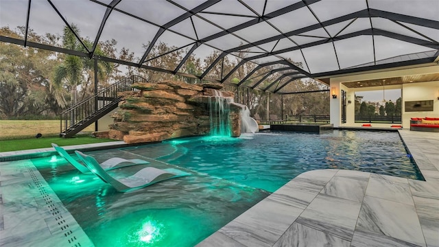 view of pool featuring pool water feature, a patio area, and glass enclosure