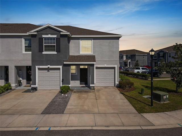 view of front facade with a garage and a lawn