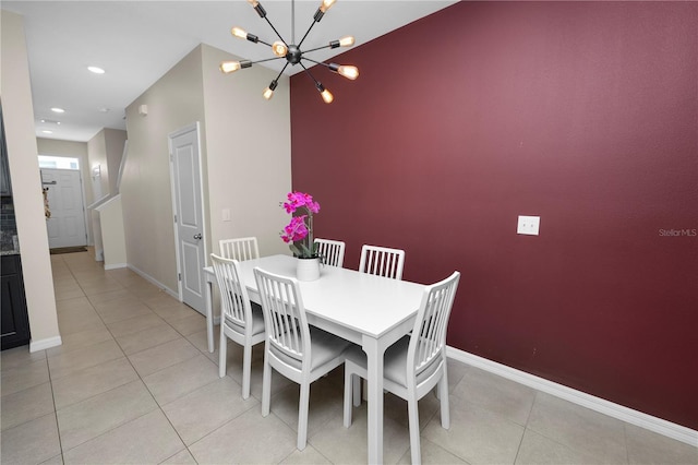 dining space featuring light tile patterned floors and a notable chandelier