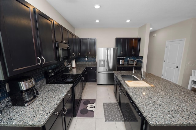 8680 Falling Blue Pl, Riverview, FL 33578 - kitchen featuring black appliances, a sink, decorative backsplash, an island with sink, and stone countertops